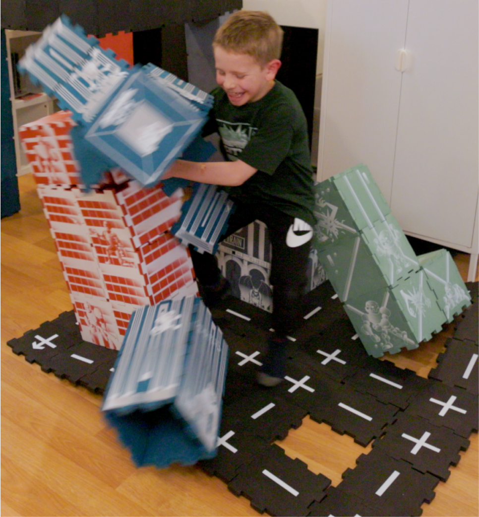Young boy destroying the foam tile Rampage City Toy